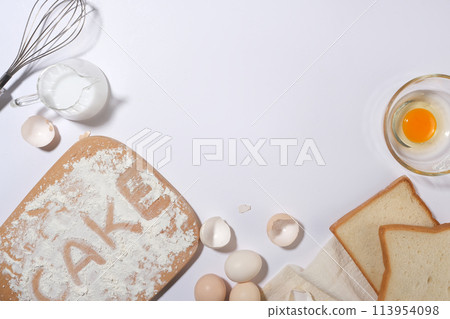 A group of baking or cooking ingredients and utensils on white background with copy space from top view, photo for displaying product 113954098