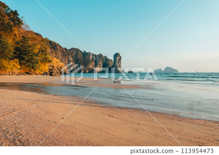 Beach and sea waves in the evening before sunset 113954473