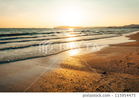 Beach and sea waves in the evening before sunset 113954475