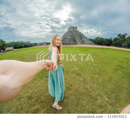 Beautiful tourist woman observing the old pyramid and temple of the castle of the Mayan architecture known as Chichen Itza these are the ruins of this ancient pre-columbian civilization and part of Beautiful tourist woman observing the old pyramid and temple of the castle of the Mayan architecture known as Chichen Itza these are the ruins of this ancient pre-columbian civilization and part of 113955021