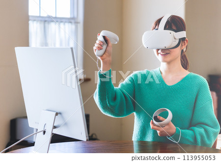 A woman enjoying virtual reality with a head-mounted display A woman enjoying virtual reality with a head-mounted display 113955053