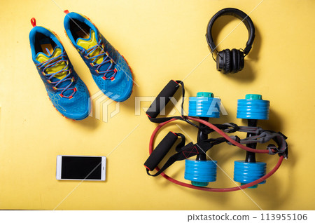 Cardio workout. Running sneakers and jump rope. Jump rope and dumbbells. Cardio with music. Flat lay. 113955106