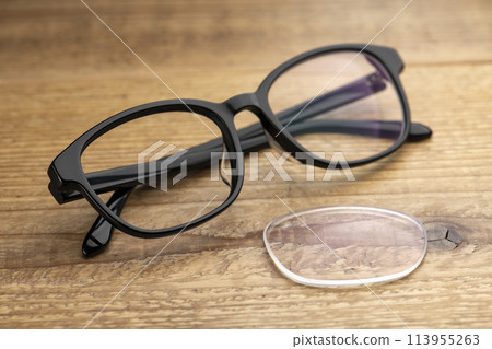 Glasses lenses on a wooden table 113955263