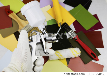 Paint spray gun at work at the workplace in the workshop. Paint Brush 113955842