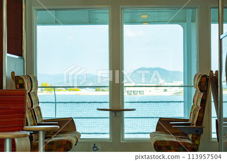 Take a ferry from a port along the Seto Inland Sea to tour the islands. View the Seto Inland Sea from a seat by the ferry's window. 113957504