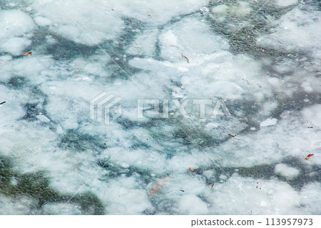 Ice surface of the river. Texture of ice shards and water. Winter background Ice surface of the river. Texture of ice shards and water. Winter background 113957973