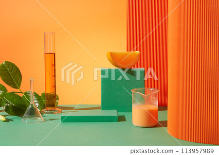 Orange background against transparent lab equipments, test tube and beaker with orange fluid filled, rectangle empty pastel green podium for displaying product made of orange. Advertising photo 113957989