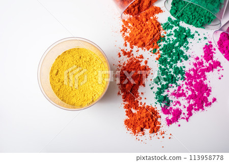 Colorful holi powder in a glass bowl on a white background. Colorful holi powder in a glass bowl on a white background. 113958778