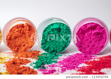 Colorful holi powder in a plastic containers on white background. 113958784