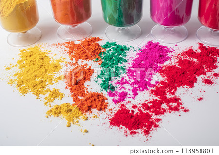 Colorful holi powder in glass isolated on white background. Holi festival concept. Colorful holi powder in glass isolated on white background. Holi festival concept. 113958801