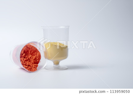 Colorful holi powder sand in measuring cup on white background 113959050