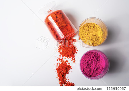 Colorful holi powder in a glass container on a white background Colorful holi powder in a glass container on a white background 113959067