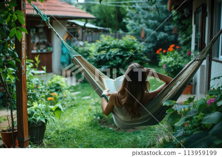 Woman reading book in a hammock 113959199