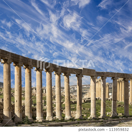 Forum (Oval Plaza) in Gerasa (Jerash), Jordan. Was built in the first century AD. Against the background of a beautiful sky with clouds. 113959832