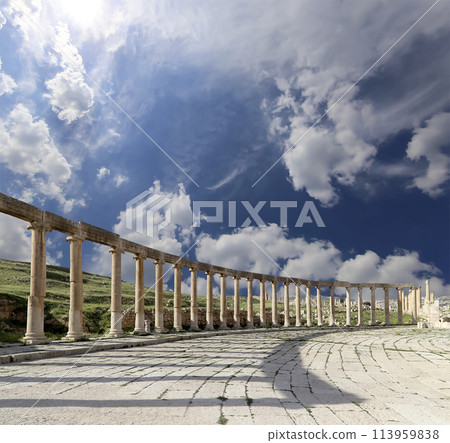 Forum (Oval Plaza) in Gerasa (Jerash), Jordan. Was built in the first century AD. Against the background of a beautiful sky with clouds. 113959838