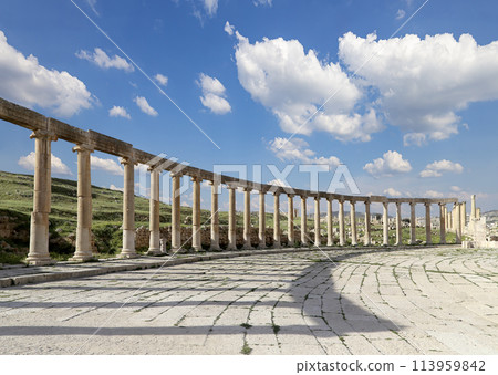Forum (Oval Plaza) in Gerasa (Jerash), Jordan. Was built in the first century AD. Against the background of a beautiful sky with clouds. 113959842