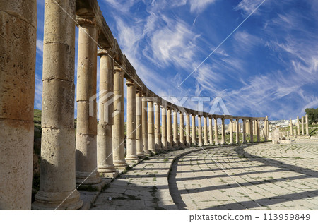 Forum (Oval Plaza) in Gerasa (Jerash), Jordan. Was built in the first century AD. Against the background of a beautiful sky with clouds. 113959849