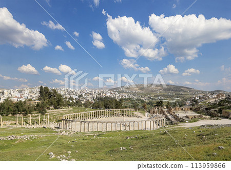 Forum (Oval Plaza) in Gerasa (Jerash), Jordan. Was built in the first century AD. Against the background of a beautiful sky with clouds. 113959866