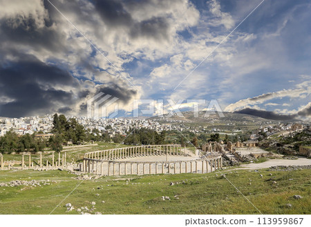 Forum (Oval Plaza) in Gerasa (Jerash), Jordan. Was built in the first century AD. Against the background of a beautiful sky with clouds. 113959867