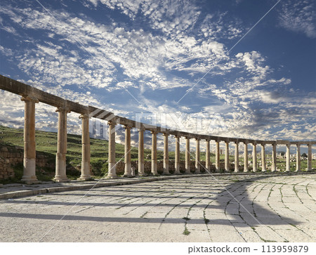 Forum (Oval Plaza) in Gerasa (Jerash), Jordan. Was built in the first century AD. Against the background of a beautiful sky with clouds. 113959879