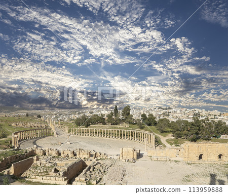 Forum (Oval Plaza) in Gerasa (Jerash), Jordan. Was built in the first century AD. Against the background of a beautiful sky with clouds. 113959888