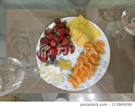 A beautiful still life of a place setting with fruit and wine 113960896