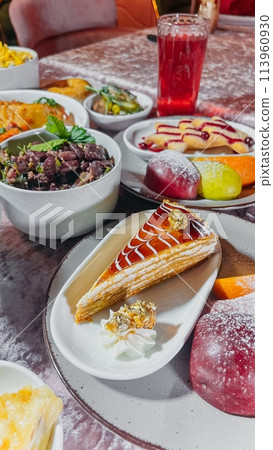 Assortment of traditional  modern dishes beautifully presented on a table. Ideal for food blog, restaurant site, or travel guide. 113960930