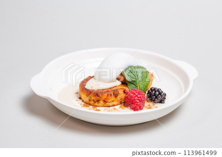 Delicious cottage cheese pancakes with raspberries and blackberries on a white background. Breakfast 113961499