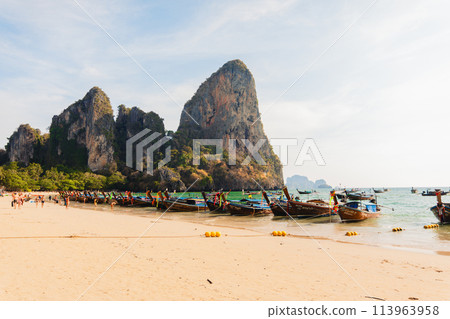 Boats and rocky mountains at Railay beach in evening 113963958