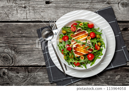 salad with grilled halloumi greek cheese in bowl 113964058