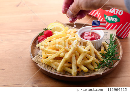 French fries on a wooden plate French fries on a wooden plate 113964515