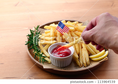 French fries on a wooden plate French fries on a wooden plate 113964539