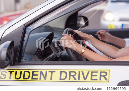 Middle-aged woman learning to drive a car 113964593