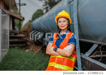 portrait train locomotive engineer women worker. Happy Asian young teen smiling work at train station train track locomotive service maintenance. portrait train locomotive engineer women worker. Happy Asian young teen smiling work at train station train track locomotive service maintenance. 113966111
