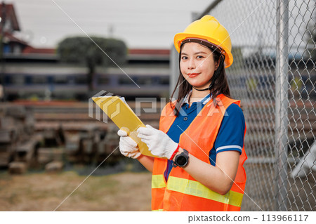 portrait Asian young teen engineer worker standing happy smile outdoor waring safety reflective with hardhat. portrait Asian young teen engineer worker standing happy smile outdoor waring safety reflective with hardhat. 113966117