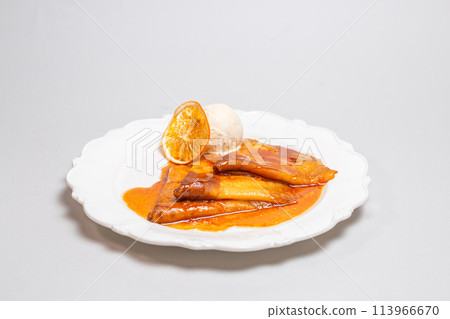 Treat yourself to luxurious pancakes with orange sauce and creamy ice cream on a white background. Maslenitsa Treat yourself to luxurious pancakes with orange sauce and creamy ice cream on a white background. Maslenitsa 113966670