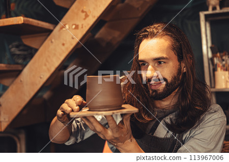 clay cup mug handcrafted man artist happy working proud look at finished hand craft product ceramic tea mug art project at workshop 113967006