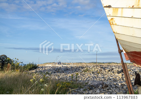 Old fishing vessel on dry land in County Donegal, Ireland 113967883