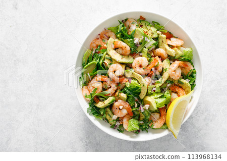 Shrimp avocado salad with lettuce and arugula, top view. 113968134