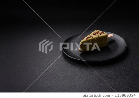 Delicious sweet cheesecake with fruits covered with icing with a wooden stick 113969354