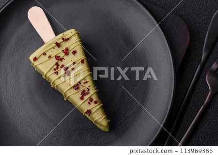 Delicious sweet cheesecake with fruits covered with icing with a wooden stick Delicious sweet cheesecake with fruits covered with icing with a wooden stick 113969366