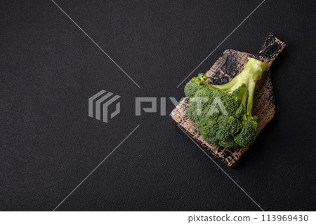 Fresh raw green broccoli in the form of a branch as an ingredient for cooking food at home Fresh raw green broccoli in the form of a branch as an ingredient for cooking food at home 113969430