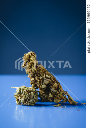 cannabis buds on a blue surface cannabis buds on a blue surface 113969432