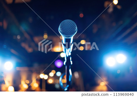 Microphone on stage against a background of auditorium. 113969840