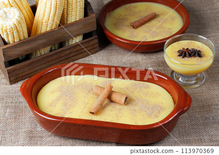 Curau, cream of corn sweet and dessert typical of the Brazilian cuisine, placed in ceramic bowl on wooden table. 113970369