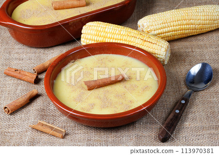 Curau, cream of corn sweet and dessert typical of the Brazilian cuisine, placed in ceramic bowl on wooden table. 113970381