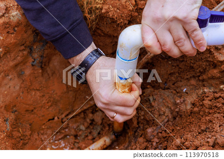 Installing glue pvc pipe to connect house to water supply Installing glue pvc pipe to connect house to water supply 113970518