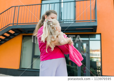 Child girl with cochlear implant with her mother spend time outdoor. Hear impairment and deaf community concept. Deaf and health concept. Disability and inclusion. Copy space 113970595