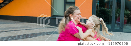 Banner Child girl with cochlear implant with her mother spend time outdoor. Hear impairment and deaf community concept. Deaf and health concept. Disability and inclusion. Copy space 113970596