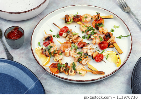 Seafood kebabs fried on sticks. Seafood kebabs fried on sticks. 113970730